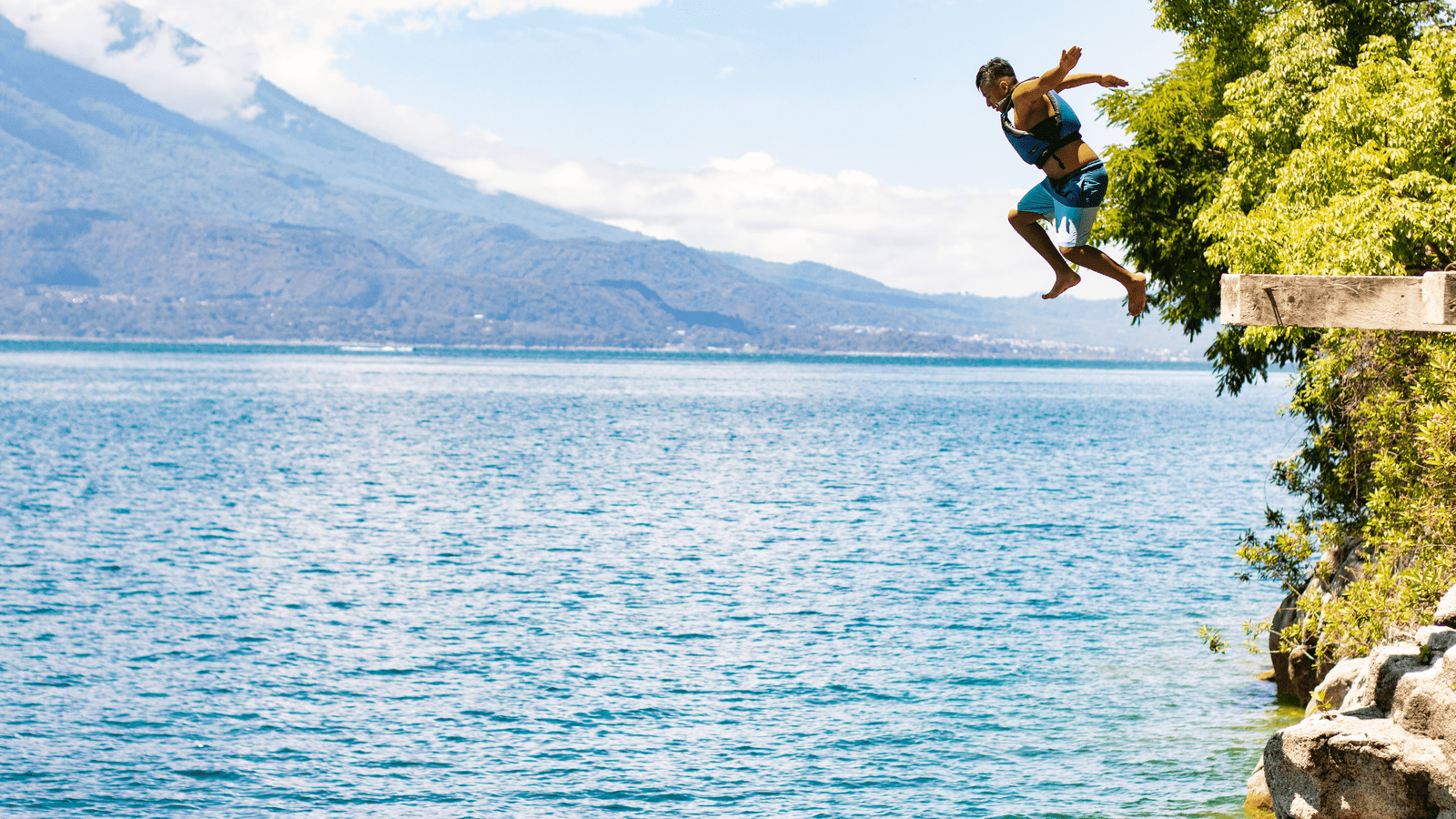 Man jumps from a two metre cliffside in Lake Atitlan.