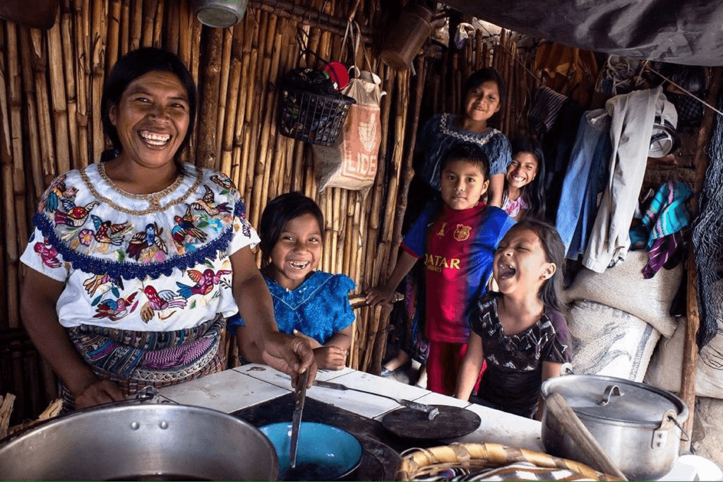 Indigenous people cooking traditional food in her home.