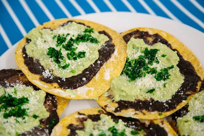 Guatemalan tostadas topped with beans and salsa